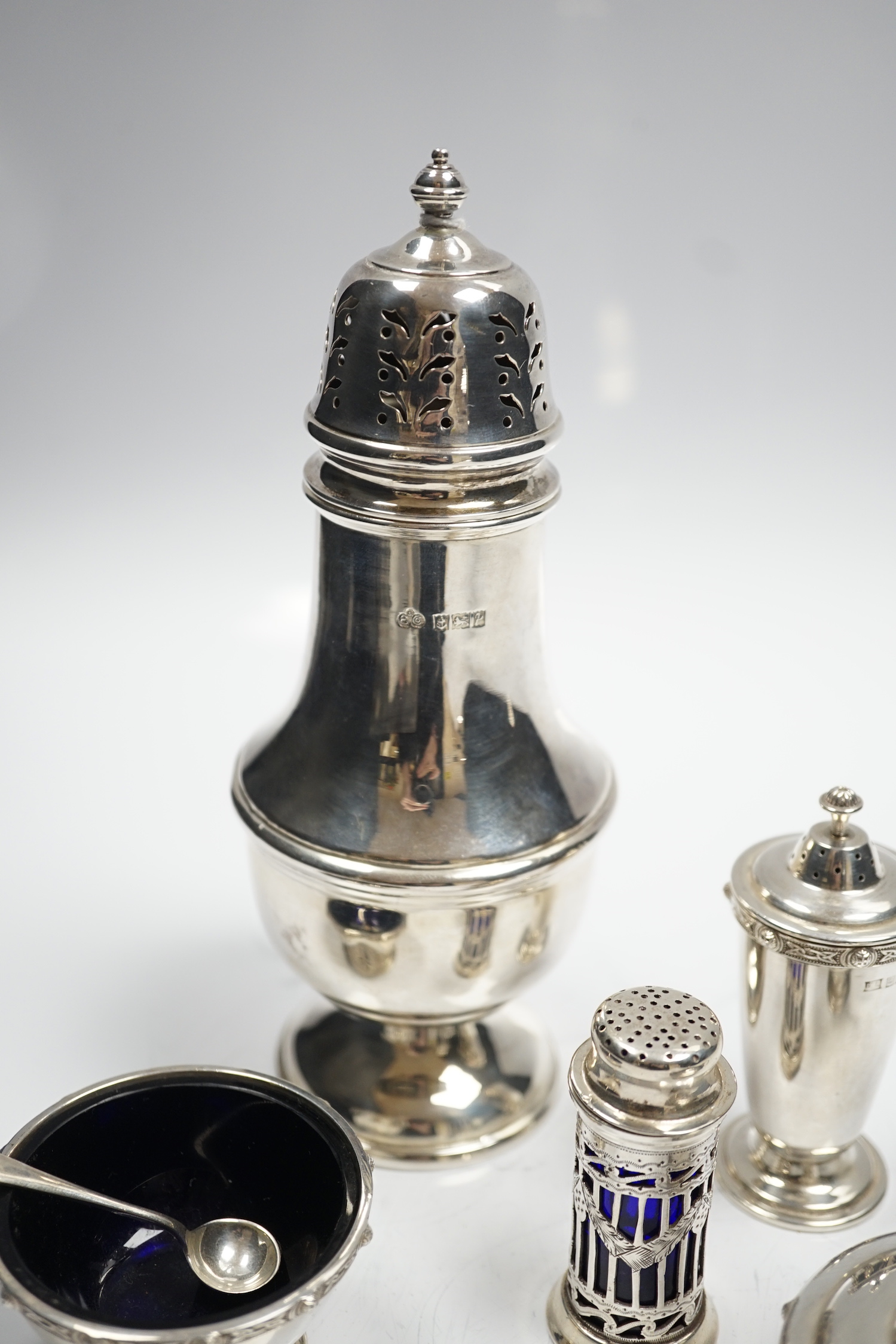 A modern silver baluster sugar caster by Elkington & Co and four assorted silver condiments.